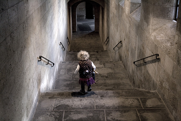 Milligan runs through a stone cloister