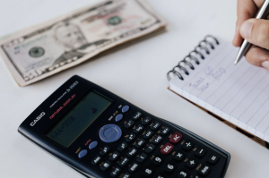 Picture of calculator, notepad and $50 bill