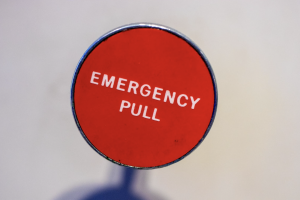 Picture of red circle with title emergency pull
