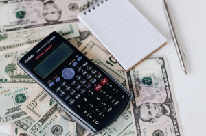 Calculator surrounded by US dollars