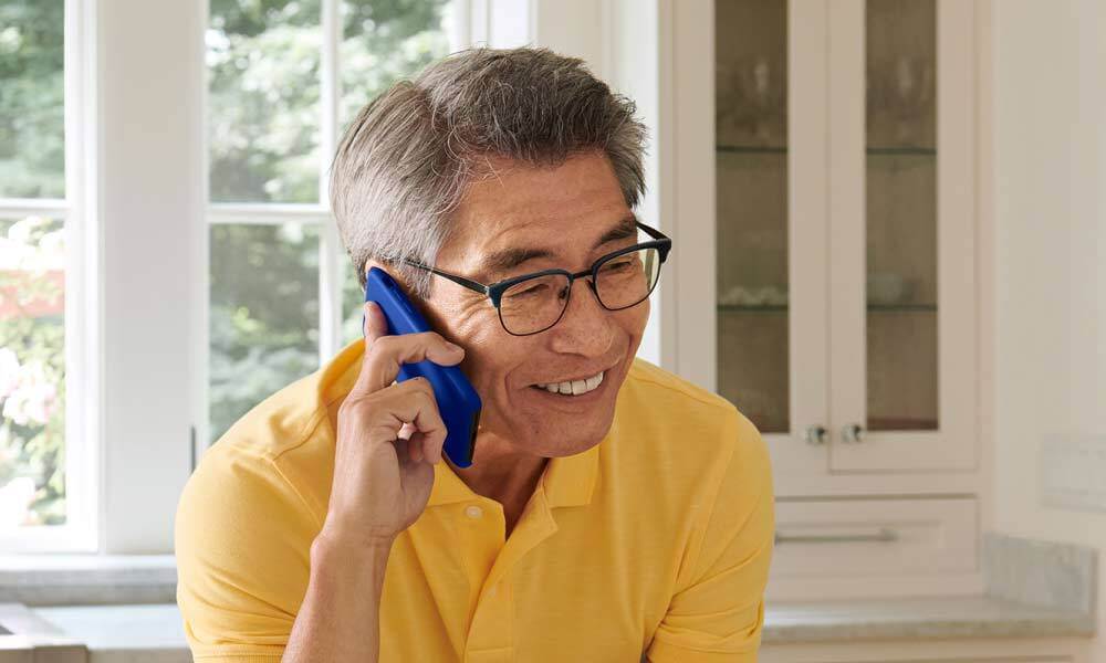 Older individual on the phone potentially asking about SSI benefits.